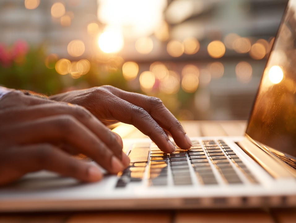 hands typing on laptop